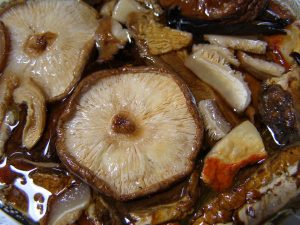 Shiitake mushrooms cooking in a pot.
