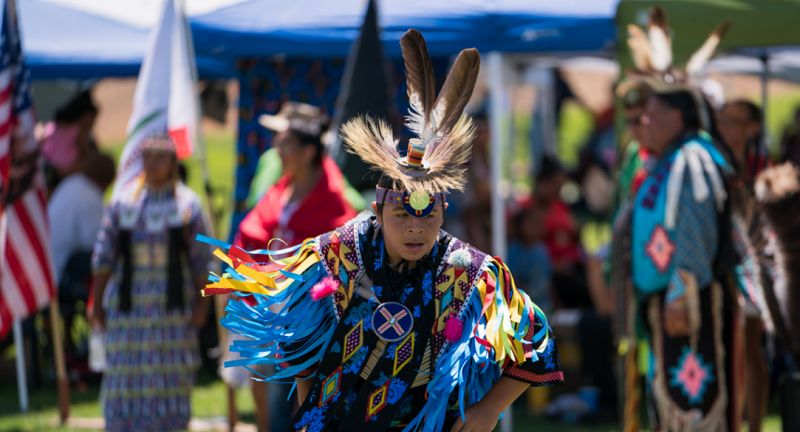 Native American dancer in full regalia performs at past Indian Fair Days in North Fork